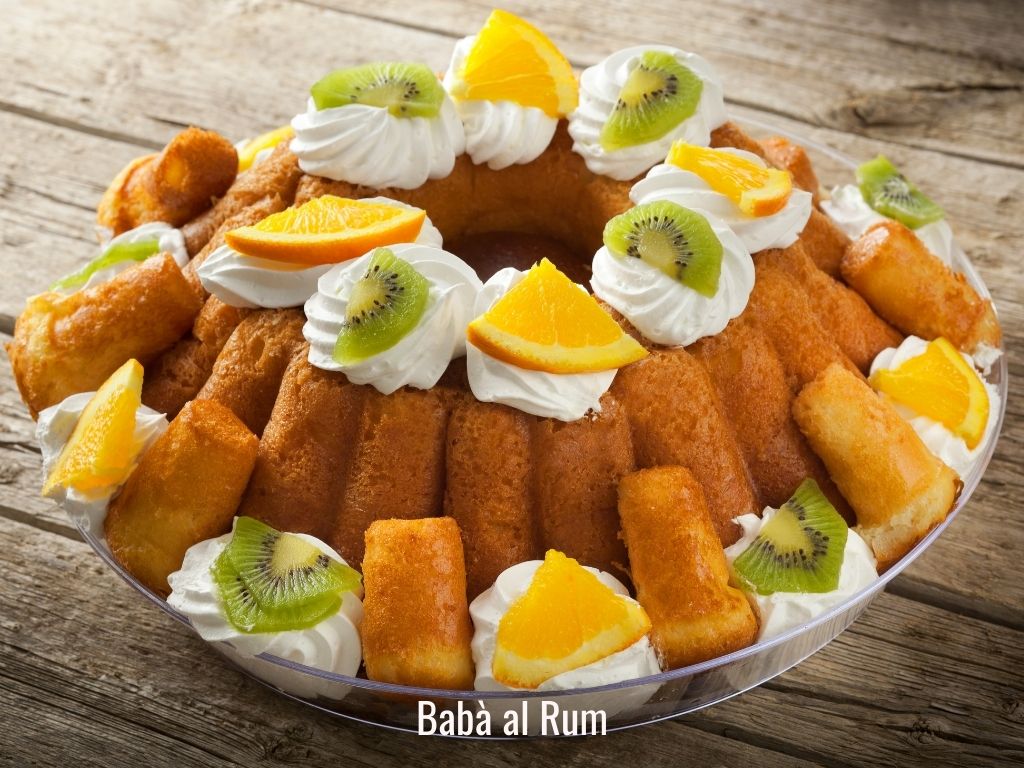 plate of baba al rum decorated with cream and fruit