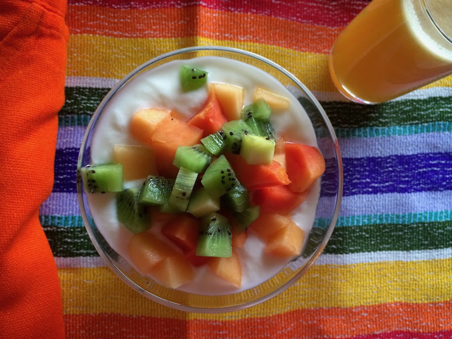 chopped tropical fruit with juice on a bright table cloth
