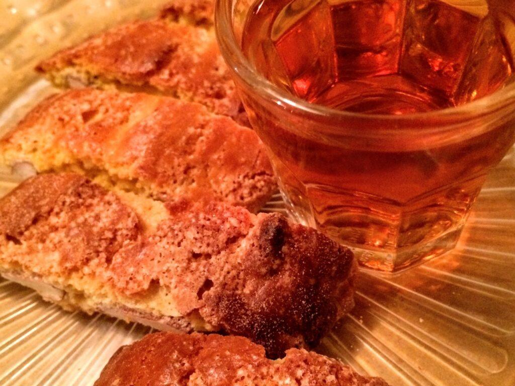 Cantucci biscotti with a small glass of vin santo honey coloured liquour in Tuscany