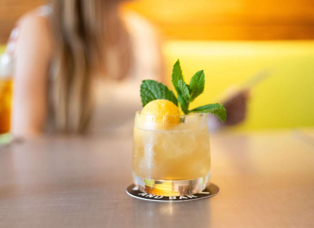 orange sgroppino cocktail with mint garnish